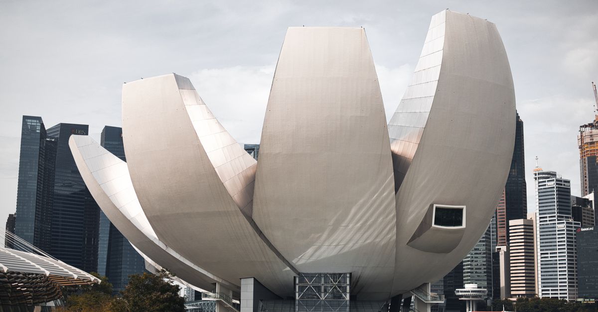 Iconic ArtScience Museum in Singapore with a backdrop of modern skyscrapers.